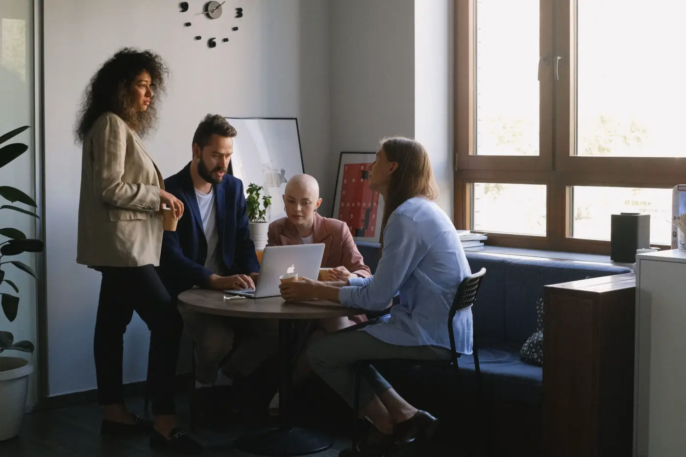 A team meeting around a table to discuss reporting and decisions