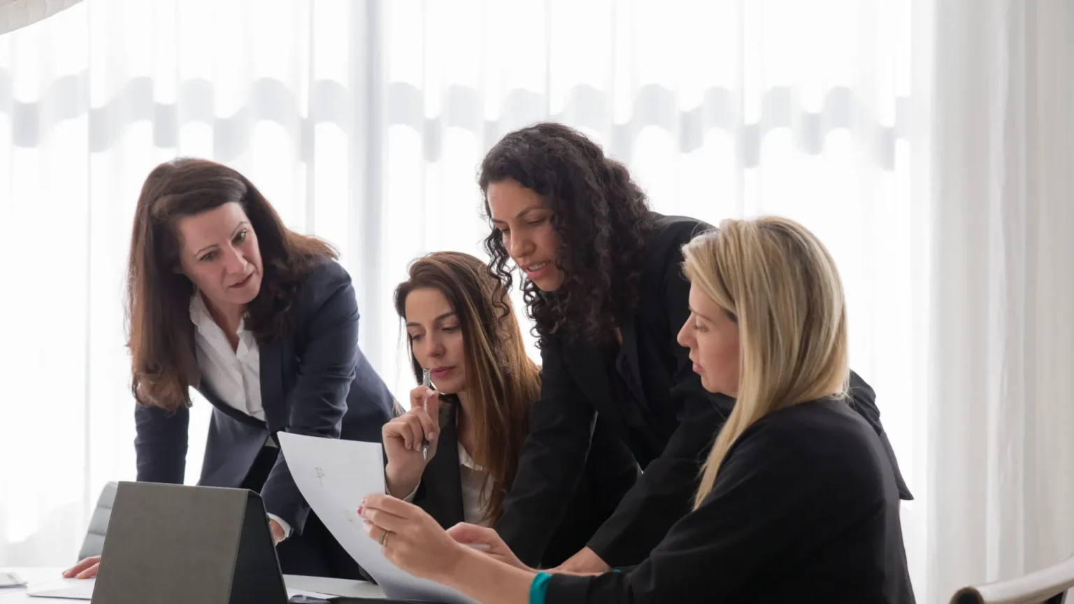 Colleagues in conversation in a modern workplace