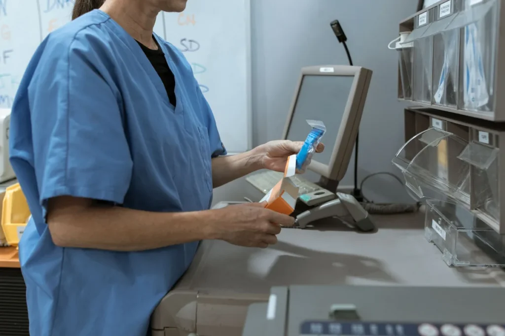 A health worker using a computer terminal in a clinical setting