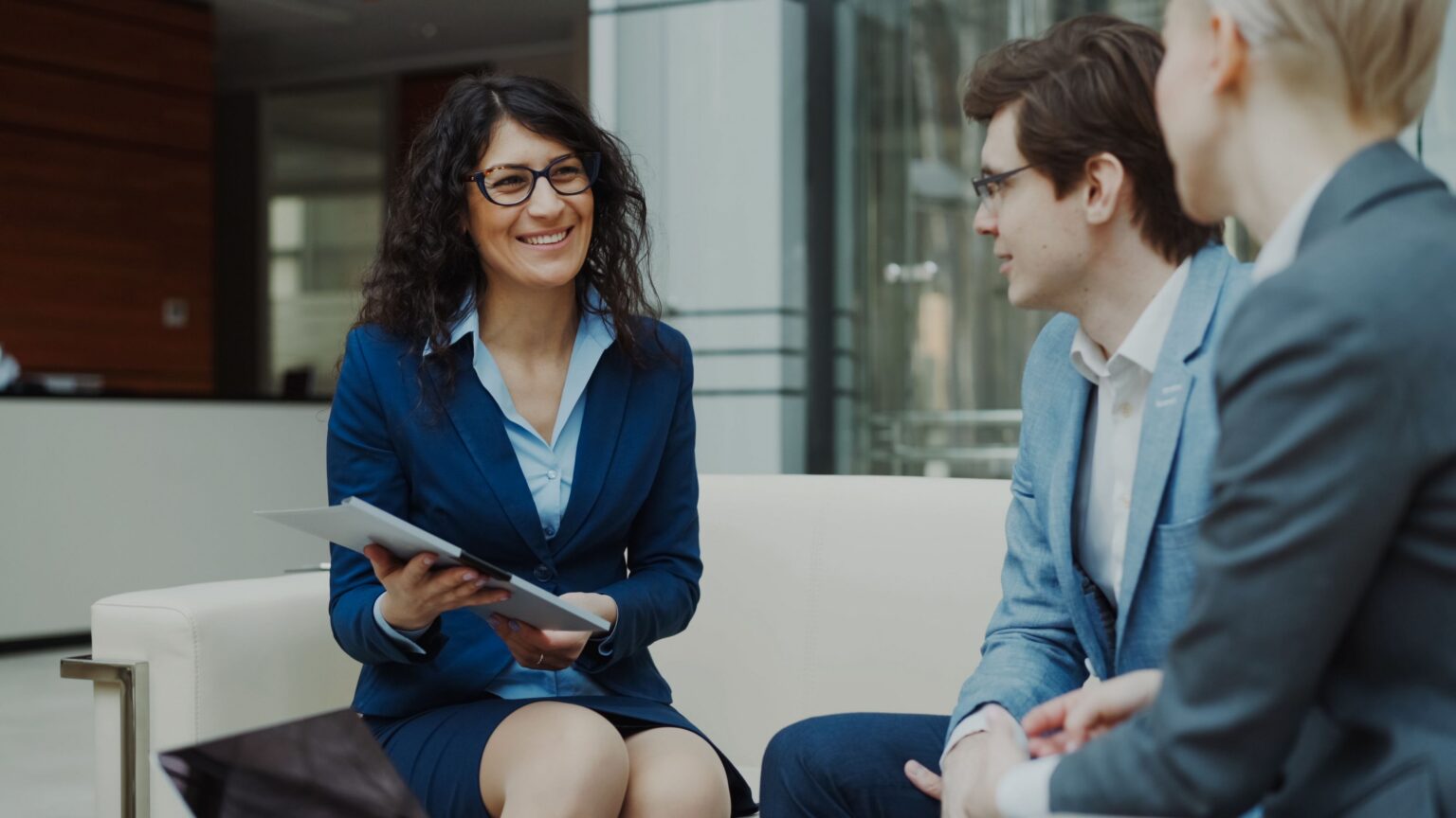 Advisers meeting with a client in a modern office to review a process improvement plan